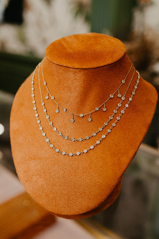 ESSENTIAL BEZEL HALF TENNIS NECKLACE is a bezel set tennis necklace in 18kt yellow gold
