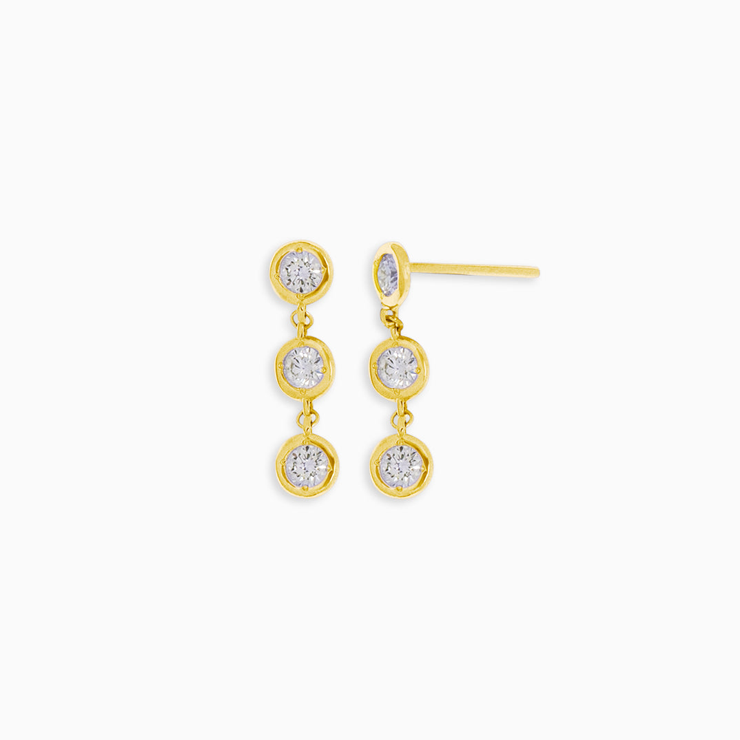 Essential Diamond Bezel Drop is a pair of earrings with 3 diamond drops each in 18kt yellow gold