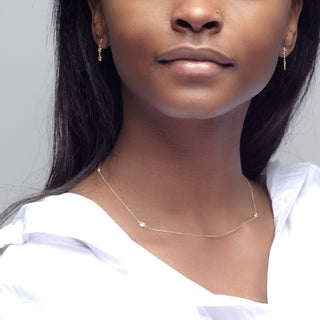 Essential Diamond Bezel Necklace in 18kt gold yellow gold with 4 diamonds worn on a woman