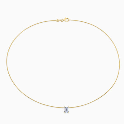 Essential Solitaire Necklace is an omega chain with a emerald cut diamond in 18kt yellow gold. 