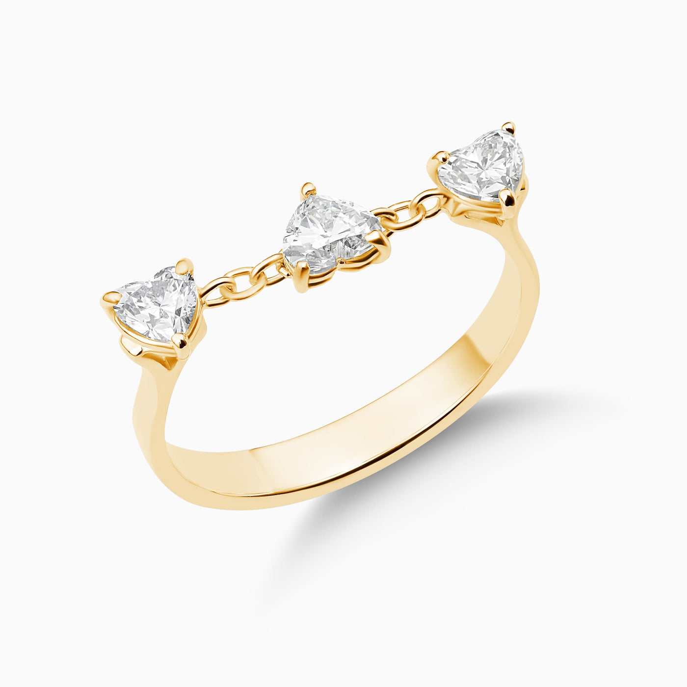 Dizzy Hearts Ring is an 18kt yellow gold ring featuring 3 heart shaped diamonds on a chain.