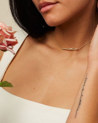 Dizzy Slide Necklace is made in 18kt yellow gold with diamonds moving on a diamond line worn on woman