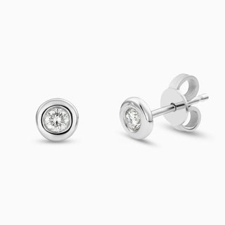 Essential Diamond Bezel Studs are diamond bezel-set studs in 18kt white gold