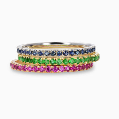  Essential Slim Ruby Band in 18kt rose gold, Essential Slim Sapphire Band in 18kt white gold and Essential Slim Emerald Band in 18kt yellow gold stacked together.
