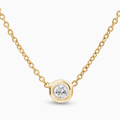 Essential Solitaire Diamond Bezel Necklace is in 18kt yellow gold with 1 diamond in the middle set in a bezel 