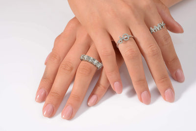 Joujou Name Band and Joujou Love Band in 18kt white gold worn by woman. Letters are customisable. 